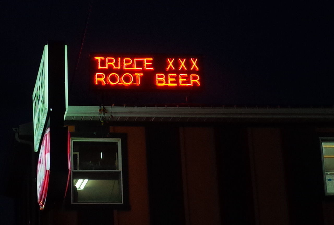 LOW ANGLE VIEW OF ILLUMINATED SIGN AGAINST BUILDING