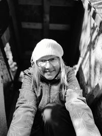 Portrait of a girl sitting outdoors and looking down 