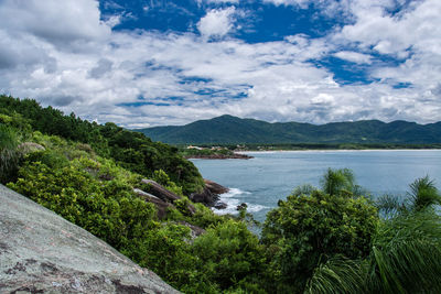 Scenic view of sea and mountains against sky