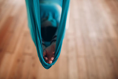 High angle view of hand in textile swing at home