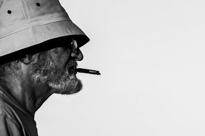 Close-up side view of cigarette against white background