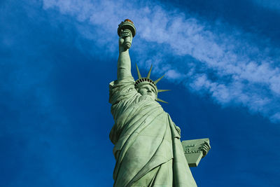 Low angle view of statue against blue sky