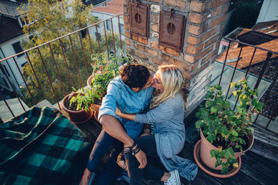 High angle view of couple kissing in balcony