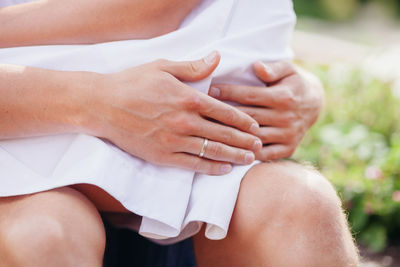 Close-up of woman touching hands