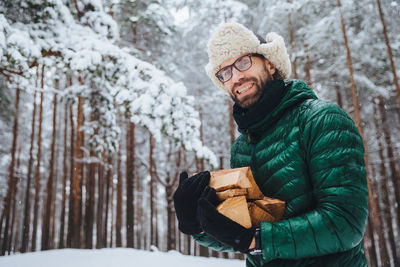 Man holding umbrella during winter