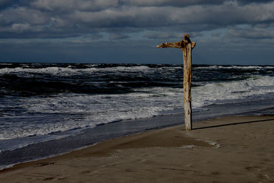 Lifeguard hut on beach against sky