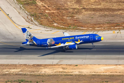 Side view of airplane on airport runway