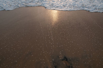 High angle view of wet sand on beach