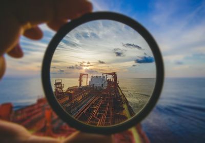 Cargo container seen through loop during sunset