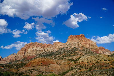 View of rocky mountain against cloudy sky