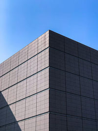 Low angle view of modern building against clear blue sky