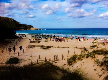 People on beach against sky