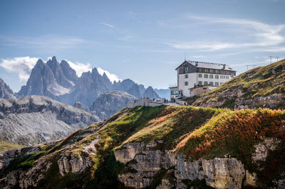 Scenic view of mountains and buildings against sky