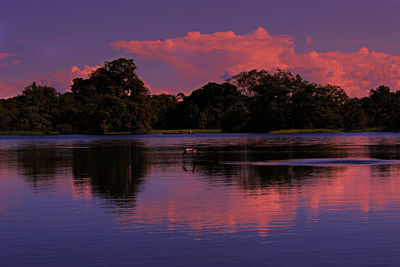 Scenic view of lake against sky at sunset