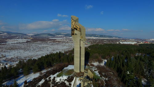 Scenic view of tower against sky during winter