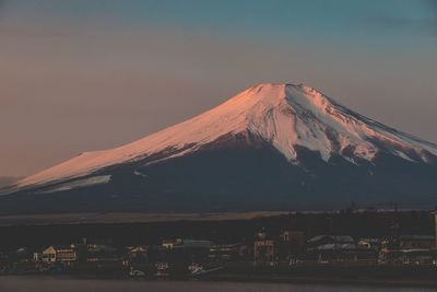 Scenic view of snowcapped mountains against sky during sunset