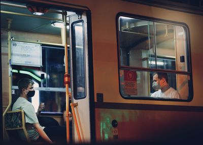 Side view of people in train