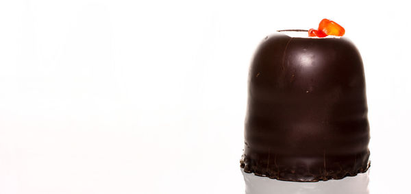 Close-up of wineglass over white background