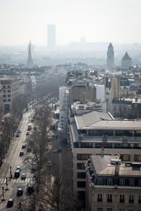 The rooftops of paris in the parisian morning mist from the top of the arc de triomphe - paris