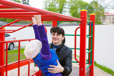Portrait of smiling young man holding while standing at playground