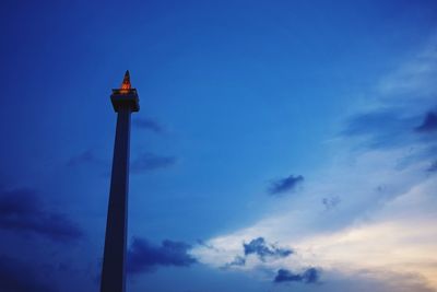 Low angle view of lighthouse against blue sky