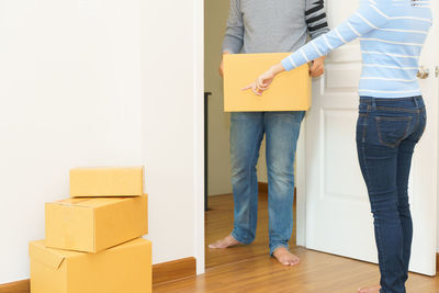 Low section of people standing on hardwood floor