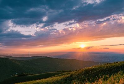 Scenic view of field against sky during sunset