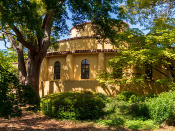 Exterior of building by trees and house