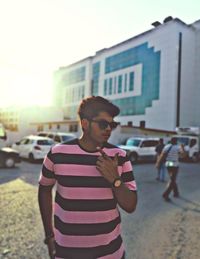 Full length of young man standing in city