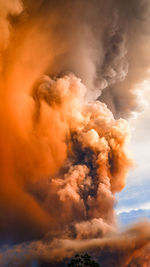 Low angle view of smoke against sky at sunset