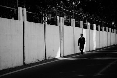 Rear view of man walking on street