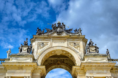 Low angle view of historical building against cloudy sky