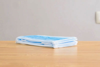 Close-up of blue papers on wooden table