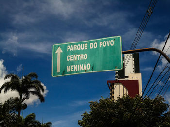 Low angle view of road sign against sky