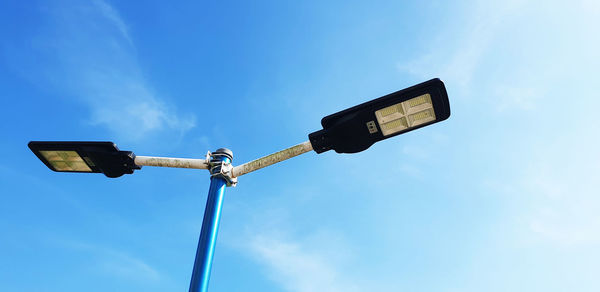 Low angle view of street light against sky