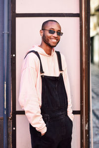 Portrait of young man wearing sunglasses standing outdoors