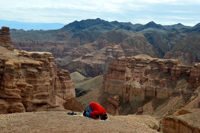 Man praying in canyon