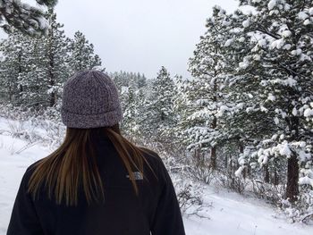 Person standing on snow covered landscape