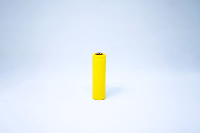 Close-up of yellow flag against blue background