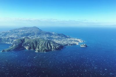 Aerial view of sea against blue sky