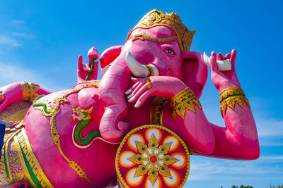 Low angle view of ganesha statue against sky