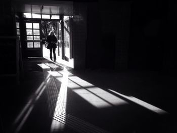 Woman entering in dark subway station