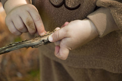 Cropped image of hand holding small baby