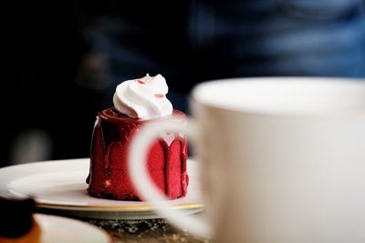 Close-up of red cake in plate on table