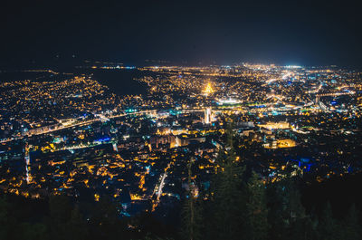 High angle view of illuminated city buildings at night