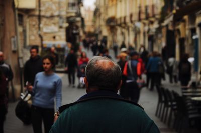 Rear view of two men in city