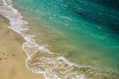 High angle view of beach that shown the gradation color from sand to sea.