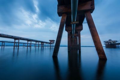 Pier over sea against sky