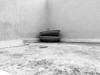 Close-up of abandoned container on wall at home