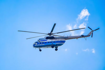 Low angle view of airplane against blue sky